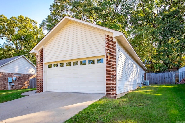 view of home's exterior featuring a yard, central AC, and a garage