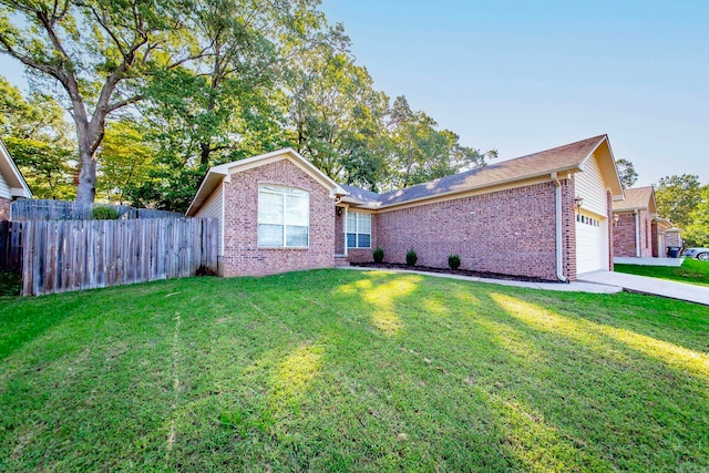 single story home featuring a front lawn and a garage