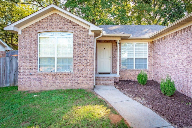 doorway to property featuring a yard