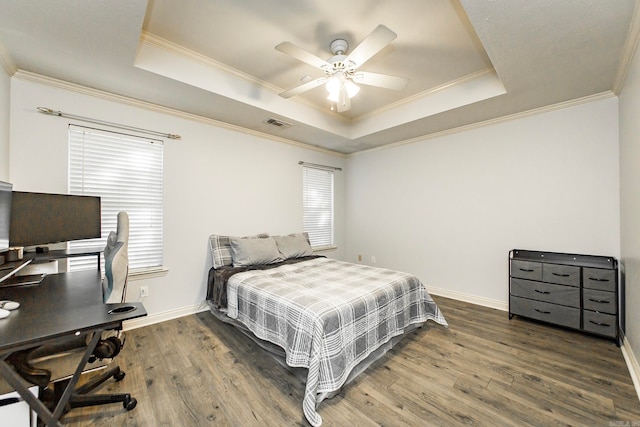 bedroom featuring crown molding, ceiling fan, dark hardwood / wood-style floors, and a raised ceiling