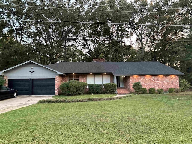 single story home with a garage and a front lawn