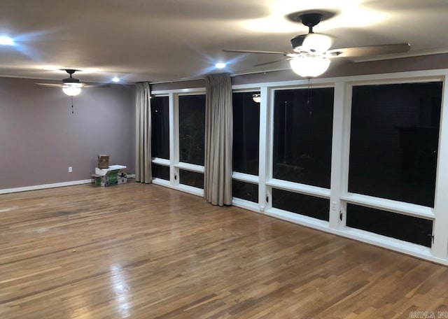 empty room featuring hardwood / wood-style flooring and ceiling fan