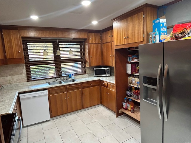 kitchen featuring stainless steel appliances, backsplash, sink, and light tile patterned floors