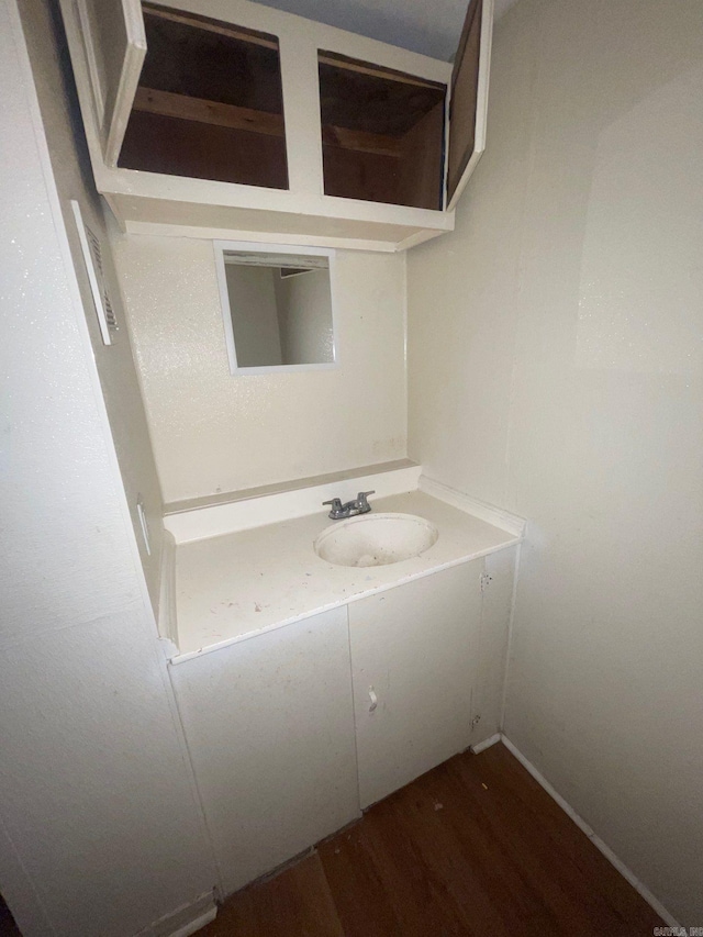 bathroom with hardwood / wood-style floors and vanity