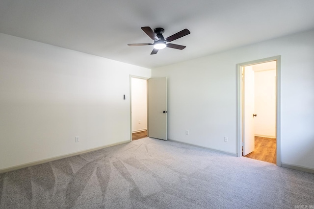 spare room featuring ceiling fan and light colored carpet