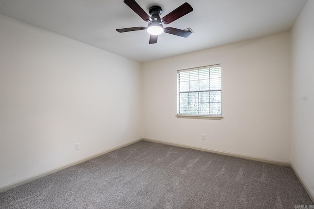 spare room featuring ceiling fan and carpet