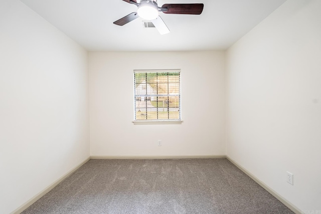 spare room featuring light carpet and ceiling fan