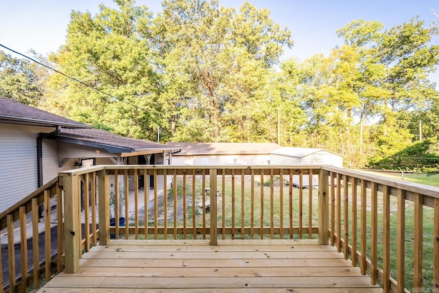 wooden terrace featuring a lawn