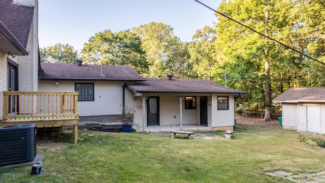 rear view of house with central AC, a patio area, a shed, and a lawn