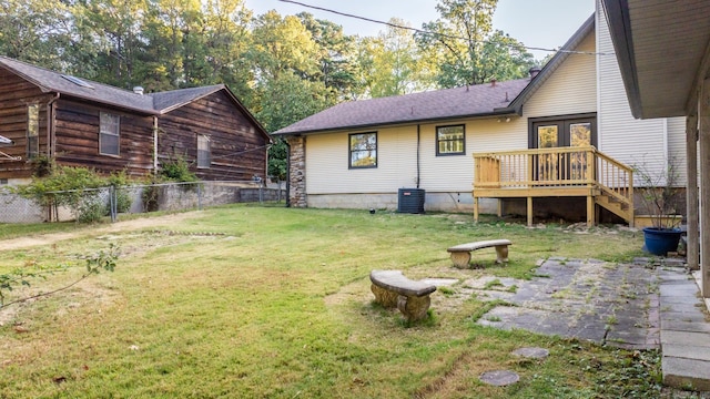 exterior space with a wooden deck and a lawn