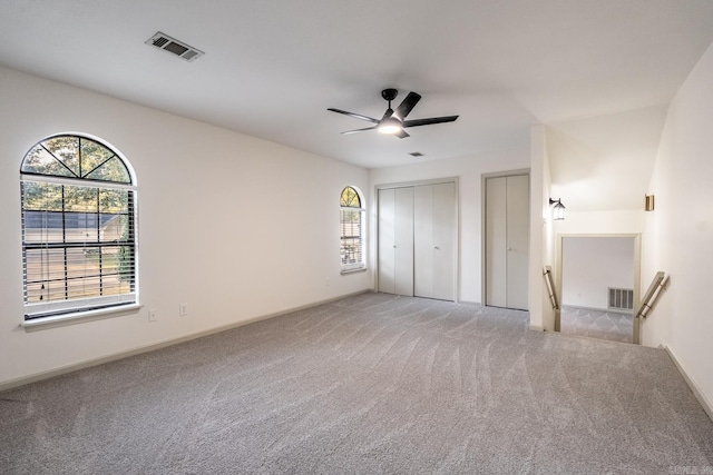 unfurnished bedroom featuring light colored carpet and ceiling fan