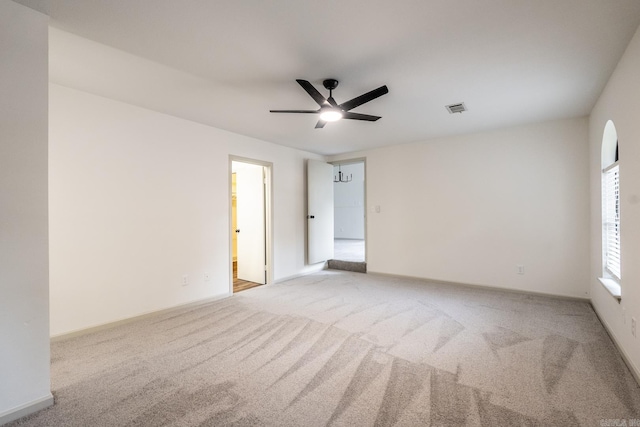 carpeted spare room featuring ceiling fan