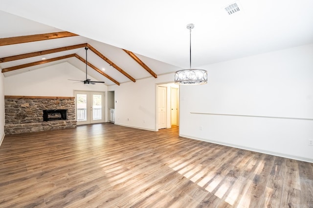 unfurnished living room with high vaulted ceiling, beamed ceiling, hardwood / wood-style floors, french doors, and ceiling fan with notable chandelier