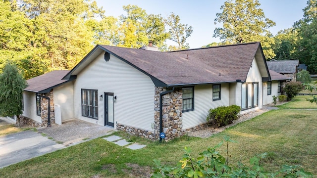 rear view of property featuring a lawn