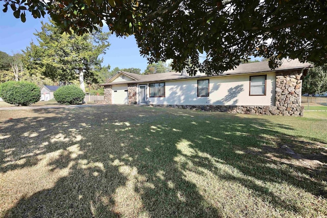 ranch-style house with a storage shed and a front yard