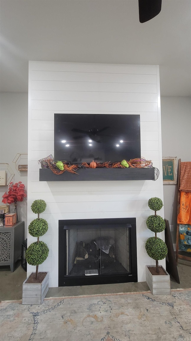 details featuring a large fireplace and concrete flooring