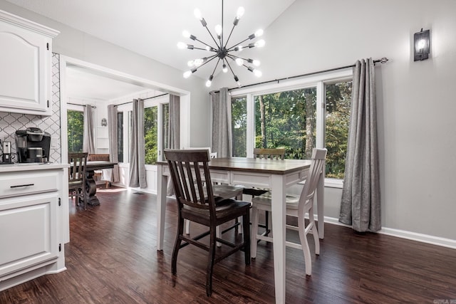 dining room with dark hardwood / wood-style floors and an inviting chandelier