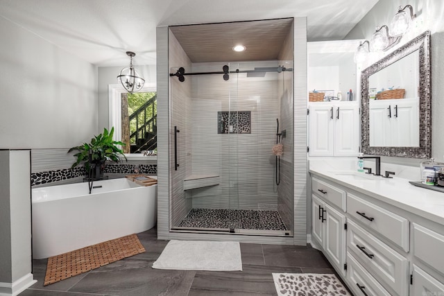 bathroom featuring a notable chandelier, vanity, and shower with separate bathtub