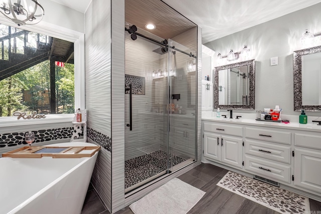 bathroom with vanity, shower with separate bathtub, and hardwood / wood-style flooring