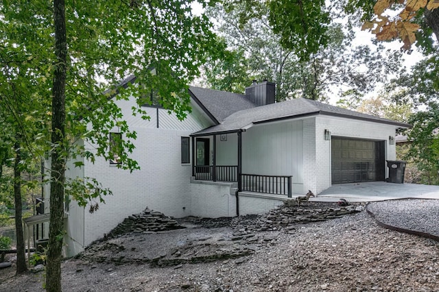 view of front of house featuring a garage and a porch