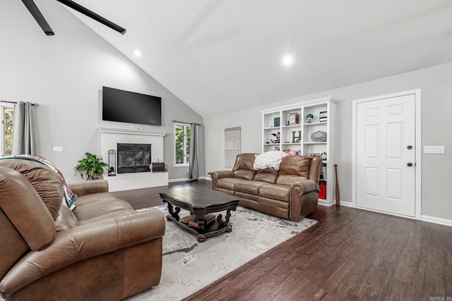 living room featuring a brick fireplace, high vaulted ceiling, ceiling fan, and dark hardwood / wood-style floors