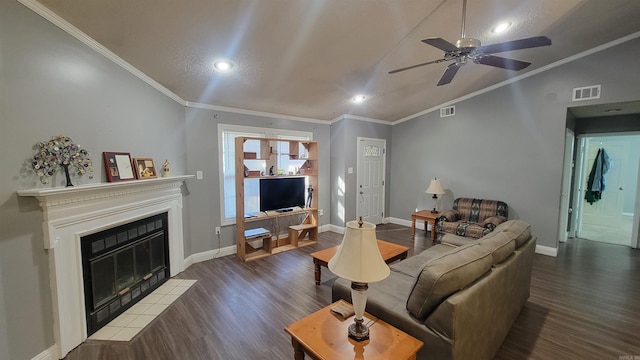 living room with lofted ceiling, ornamental molding, dark hardwood / wood-style flooring, and ceiling fan