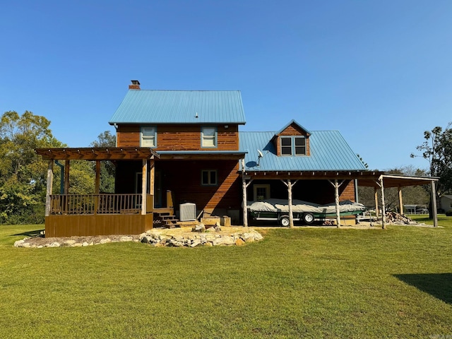 rear view of property with a yard, metal roof, a chimney, and central AC unit