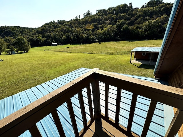 wooden deck featuring a yard and a forest view