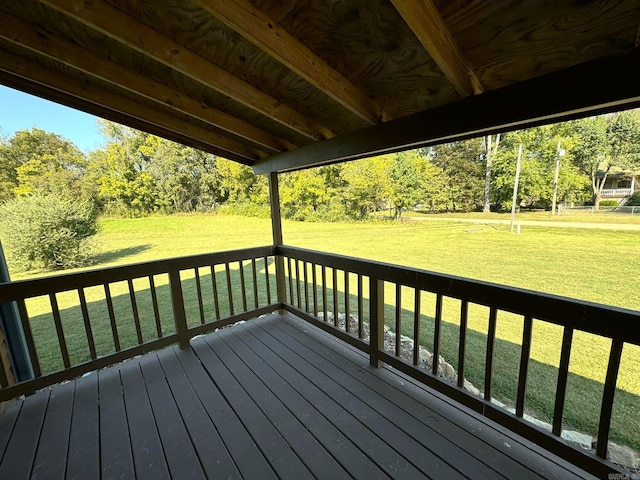 wooden deck featuring a lawn