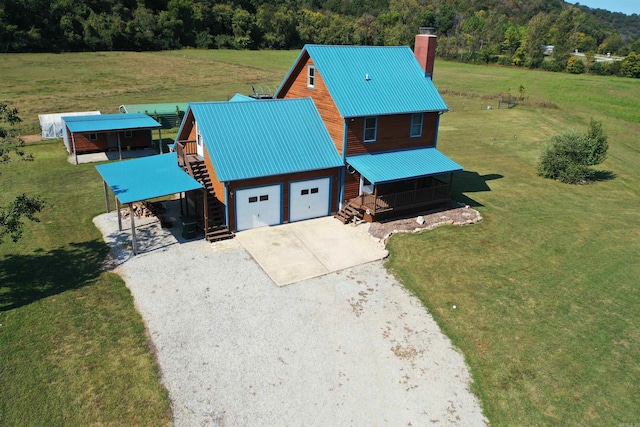 birds eye view of property featuring a forest view and a rural view