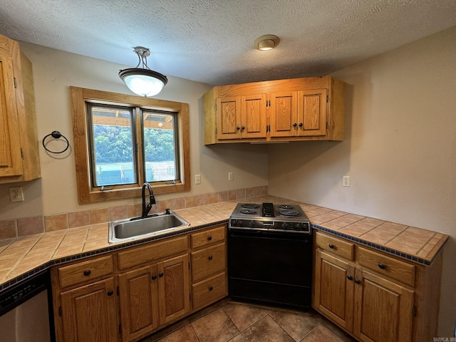 kitchen featuring tile countertops, brown cabinetry, electric stove, dishwasher, and a sink