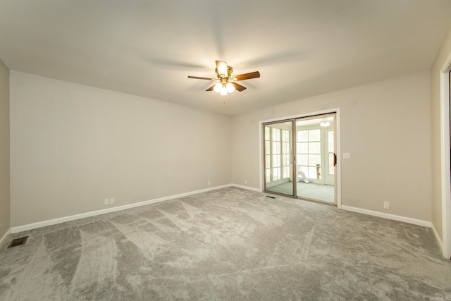 carpeted spare room featuring ceiling fan