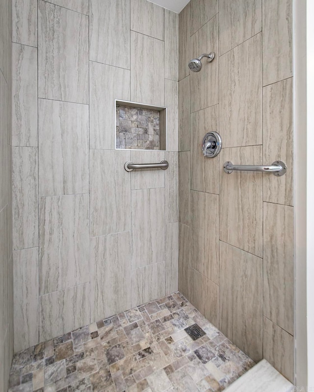 bathroom with tiled shower