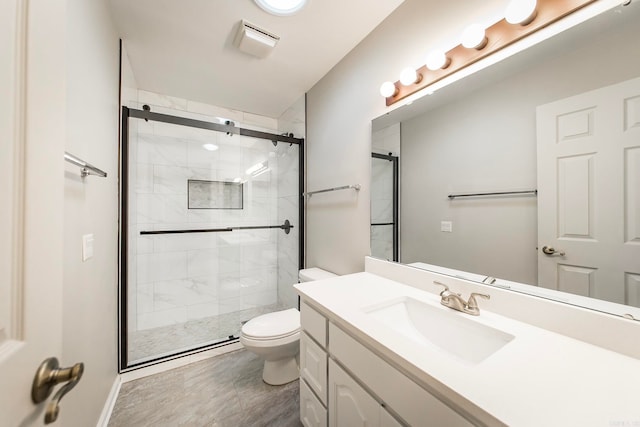 bathroom featuring walk in shower, vanity, and toilet