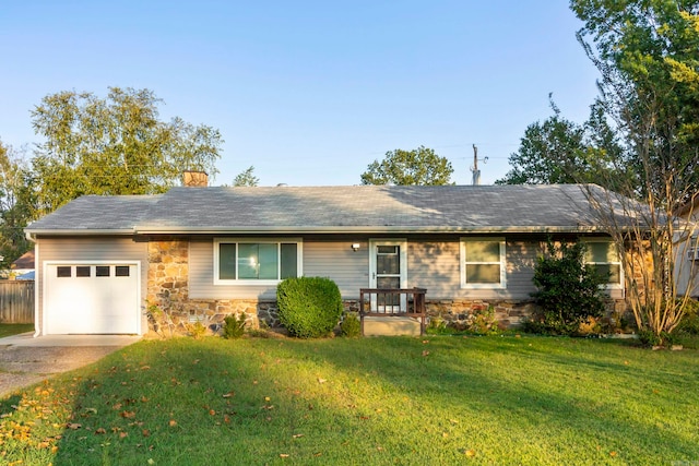 ranch-style home with a front yard and a garage