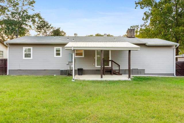 rear view of house featuring central AC, a lawn, and a patio area