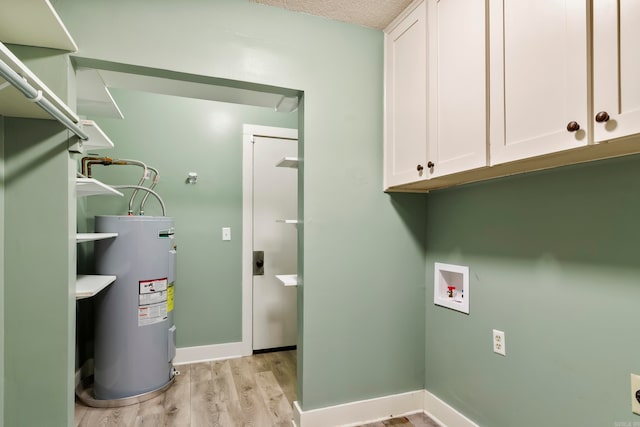 interior space with cabinets, hookup for a washing machine, electric water heater, light hardwood / wood-style floors, and electric dryer hookup