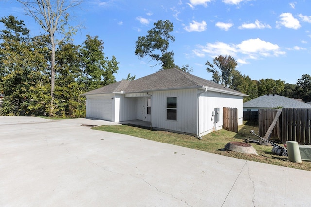 view of property exterior featuring a garage and a yard