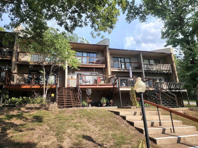 rear view of property featuring a wooden deck