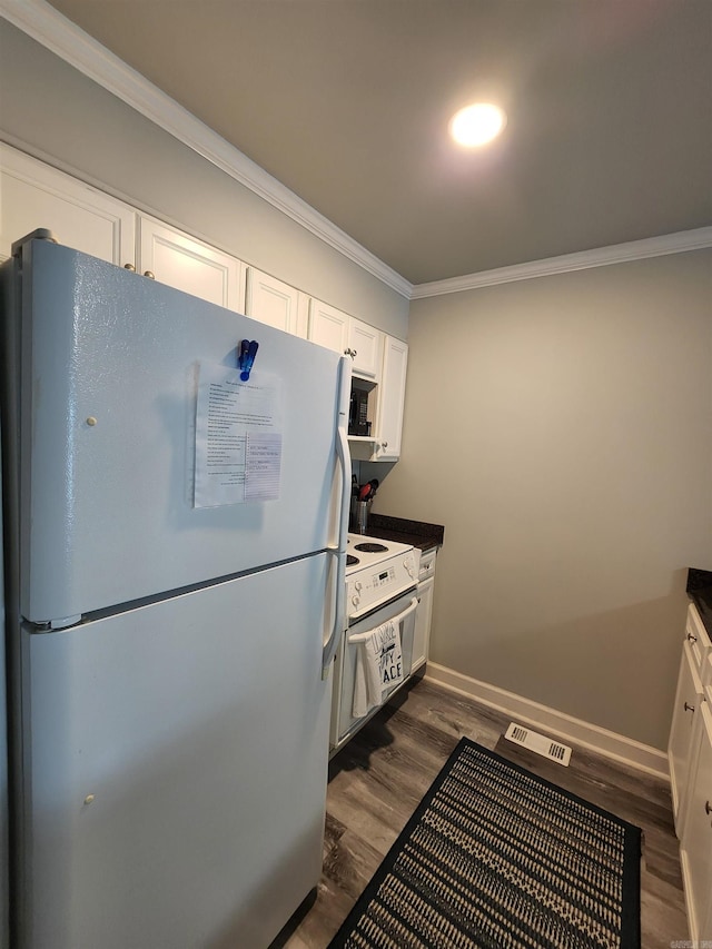 kitchen with white appliances, dark hardwood / wood-style floors, crown molding, and white cabinetry