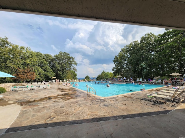 view of swimming pool with a patio area