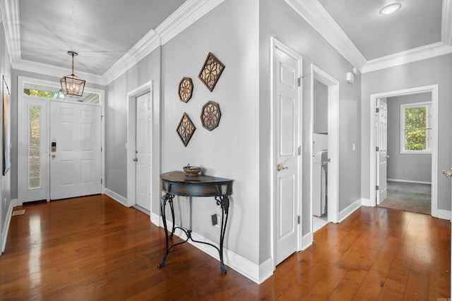 foyer entrance with crown molding, hardwood / wood-style floors, and a chandelier