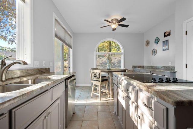 kitchen with ceiling fan, sink, light tile patterned flooring, black electric stovetop, and dishwasher