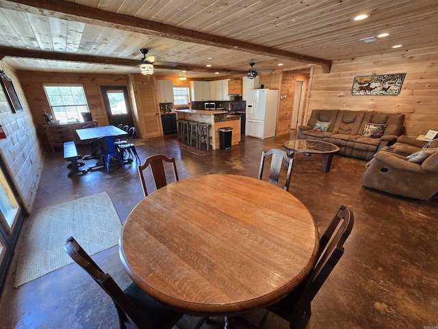 3189 Brownsville Rd, Greers Ferry, AR 72067 - dining area featuring concrete flooring, ceiling fan, wood walls, recessed lighting, and wooden ceiling with exposed beams