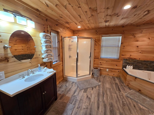 bathroom featuring wood ceiling, wooden walls, shower with separate bathtub, hardwood / wood-style flooring, and vanity