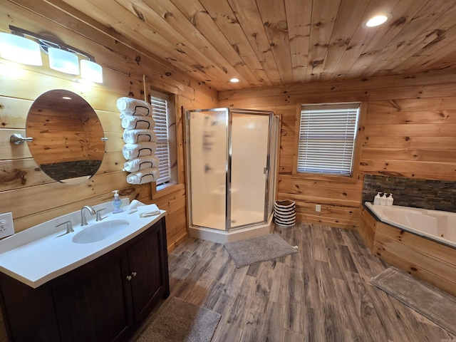 3189 Brownsville Rd, Greers Ferry, AR 72067 - bathroom featuring wooden walls, vanity, a stall shower, a garden tub, and wood finished floors