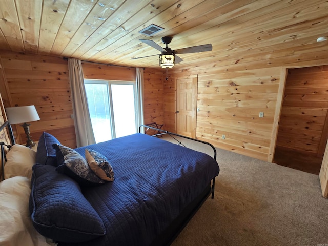 bedroom featuring carpet floors, wood ceiling, wooden walls, and ceiling fan