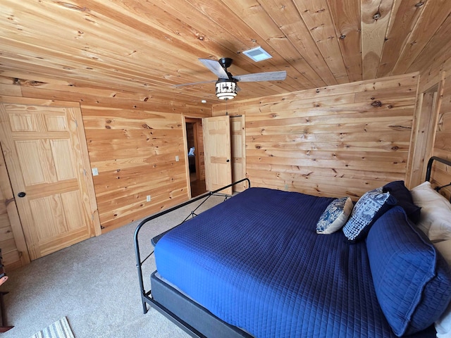 carpeted bedroom with wood walls, wood ceiling, and ceiling fan