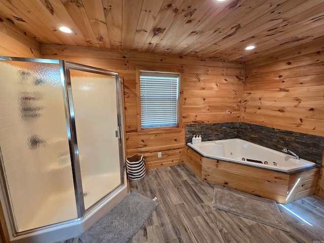 bathroom featuring plus walk in shower, wood ceiling, hardwood / wood-style flooring, and wooden walls