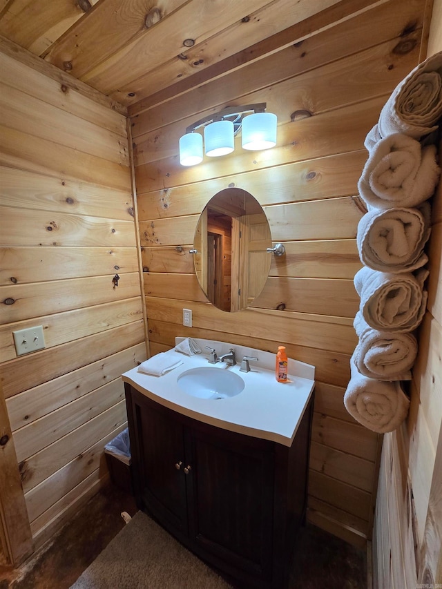 bathroom with vanity and wooden walls